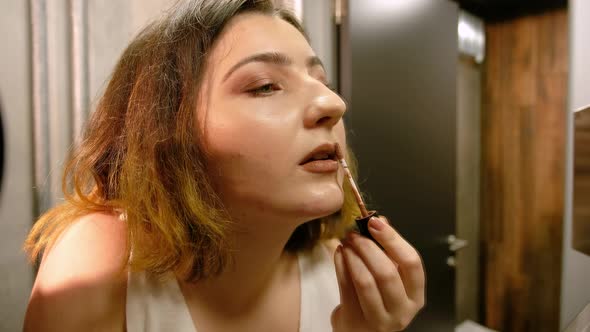  Woman Putting on Make-up Before Going Out