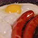 Frying two eggs and sausages in a lot of sunflower oil - VideoHive Item for Sale