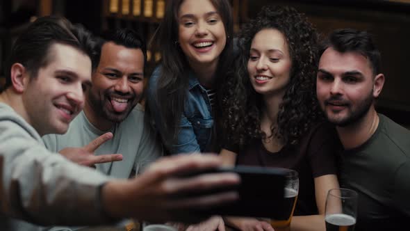 Handheld video of friends taking selfie in the pub. Shot with RED helium camera in 8K.