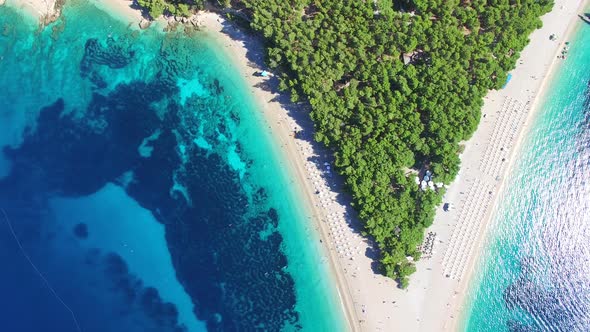 Flying over of the sandy beach Zlatni rat on the island of Brac, Croatia