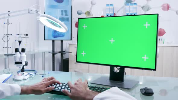 Doctor Hands Typing on Computer Mock Up Green Screen
