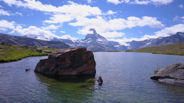 Aerial travel drone view of Zermatt at the Stellisee Lake, Mount Matterhorn, Switzerland.