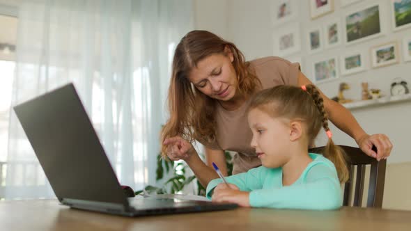 Girl Schoolgirl With A Woman Mother Does Home Lessons