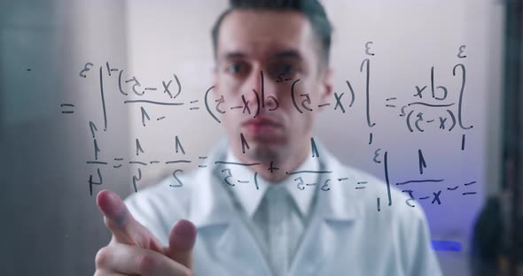 Man Scientist Thinks Over the Solution of the Integral Equation Drawn on a Glass Board in a