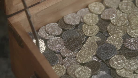 Gold Coins landing in a treasure chest.