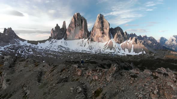 Aerial Man Hiker Walk In Front of Tre Cime di Lavaredo Mountain in Dolomites Italy