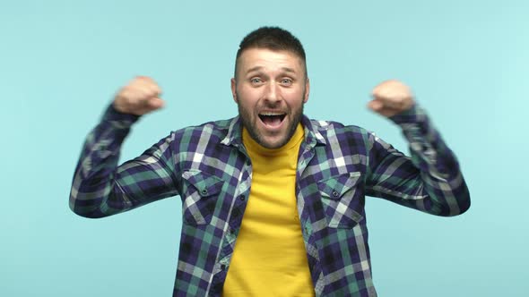 Slow Motion of Happy and Excited Male Sport Fan Cheering and Rooting for Team Smiling and Making