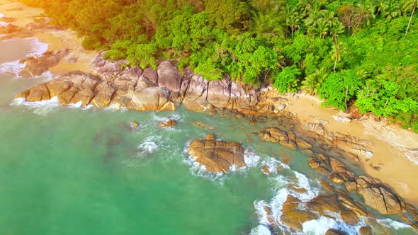 Aerial Top views over beaches, ocean waves crashing on rocks and sand