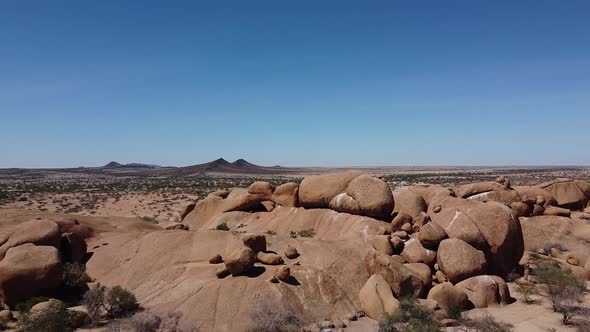 Huge round rocks and mountains on the horizon of a desert, Erongo, Namibia