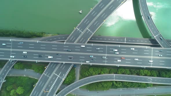 Aerial Drone Top Down View of Highway Multilevel Junction Road with Moving Cars at Daytime