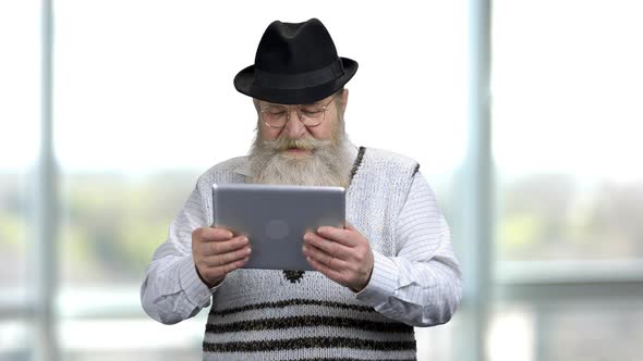 Old Retired Man Moving Tablet Pc Left and Right Playing Racing Games