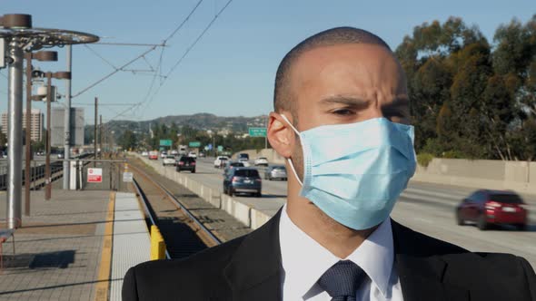 Businessman in a suit waits for a train