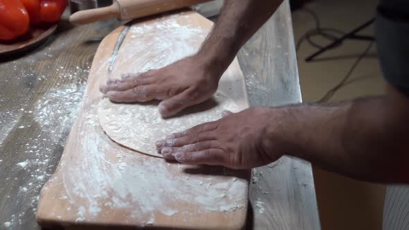 Male Hands Sprinkle Flatbread with Flour for the Video About Food