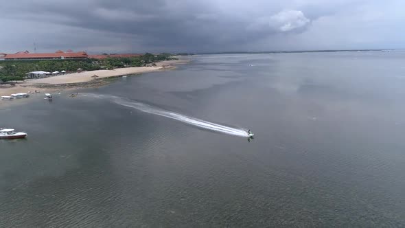 Aerial view of jet ski driving on transparent water, Bali island, Indonesia.