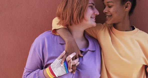 Multiracial lesbian couple holding hands and having tender moment together