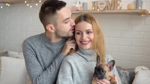 A Couple in Love with Their Dog in the Living Room