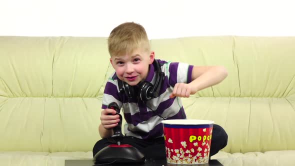 Kid Eats Popcorn and Plays Joystick Online Game, Slow Motion