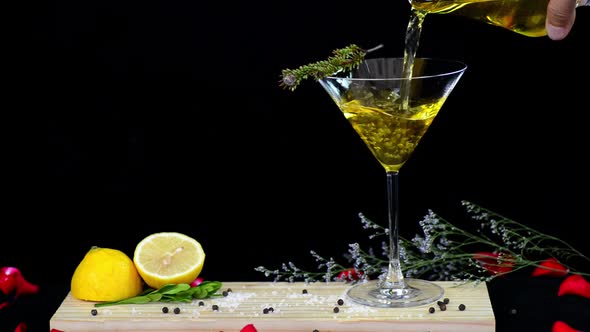 Bar keeper pouring sweet liquor served on wooden tablet with fresh citron deco