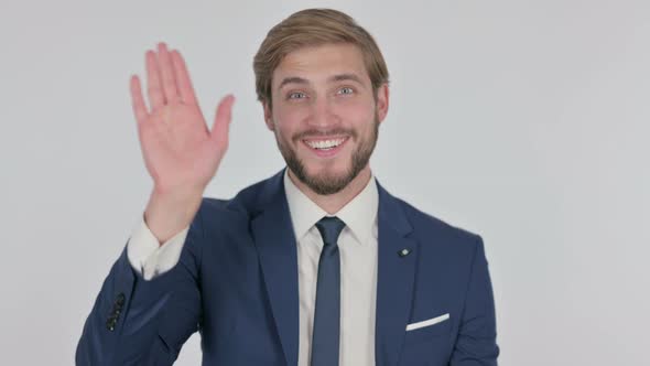 Young Businessman Waving Hand to Say Hello on White Background