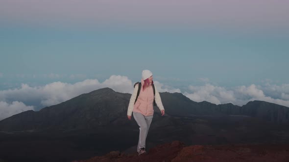 Happy Smiling 30s Woman Hiking Up Haleakala Volcano Mountain at Pink Sunset