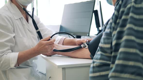 Doctor is Measuring Patient's Blood Pressure