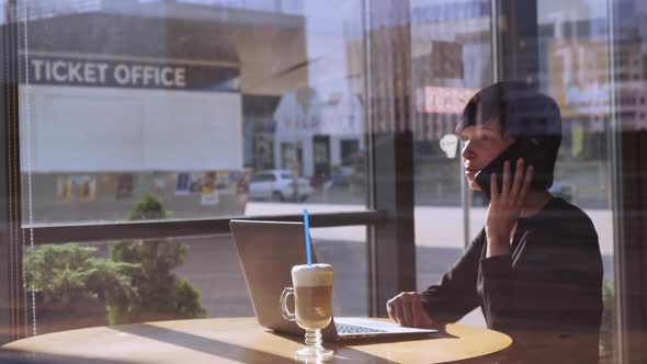 Businesswoman Talking By Mobile in Coffeehouse