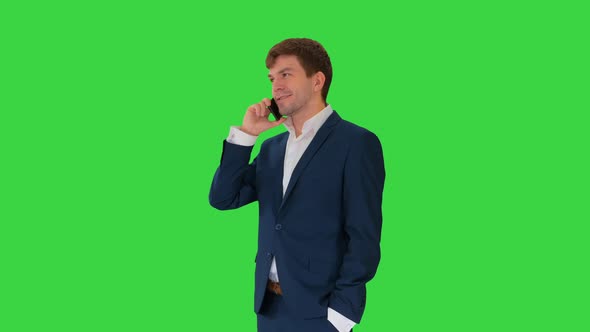 Handsome Young Businessman Talking on the Phone on a Green Screen, Chroma Key.