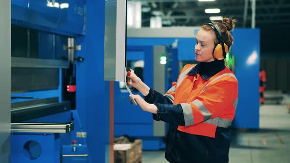 Factory Worker Is Managing Industrial Machine Through Screen