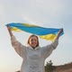 A Young Woman is Waving the Ukrainian Flag on Sunset - VideoHive Item for Sale