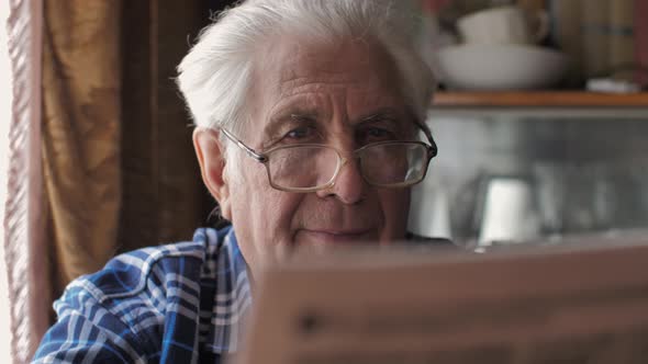 Portrait of Senior Man Reading a Newspaper