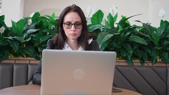 Young Professional Female Manager Using Laptop in Mall Businesswoman Working From Cafe Via Laptop