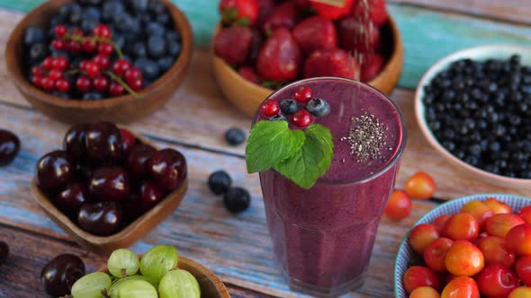 Pouring Chia Seeds on a Beautiful Berry Smoothie.