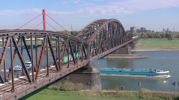Freight Train Crossing an Iron Bridge Spanning a River
