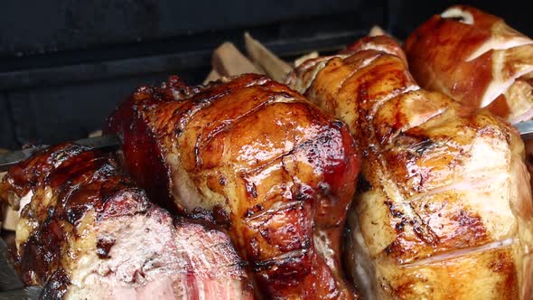 Close up pork meat roasted on open wood fire