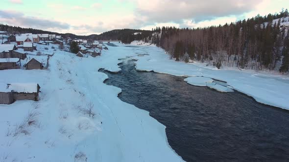Umba village in winter (Kola Peninsula). Snow and river under the ice. Aerial