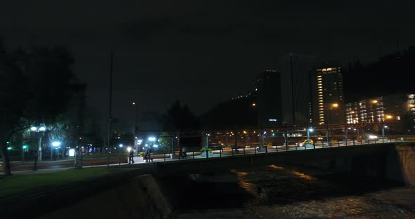 People Crossing Bridge Over River Urban Aerial Drone Flying