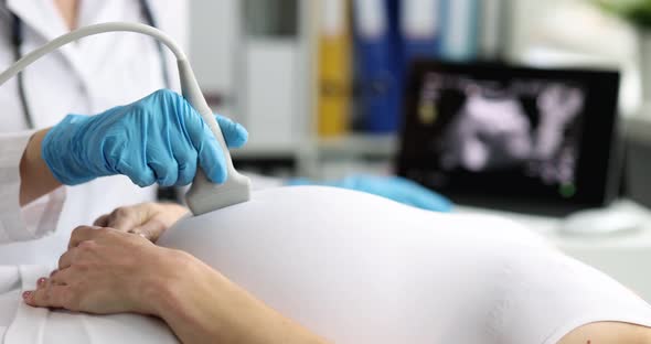 Pregnant Woman Undergoes Ultrasound in Clinic Closeup