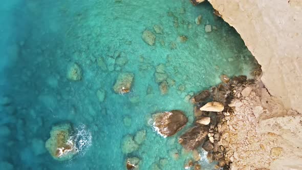 Aerial drone view of the Ionian Sea coast of Zakynthos, Greece. Rocky cliff, blue water