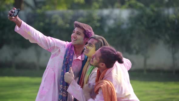 Indian boys taking selfies on Holi