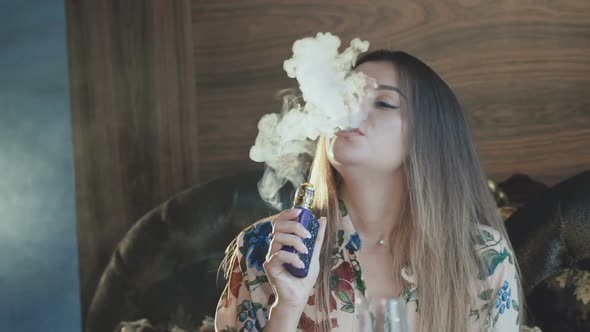 Passionate Lady Smoking E-cigarette and Breathing Out Through Mouth and Nose