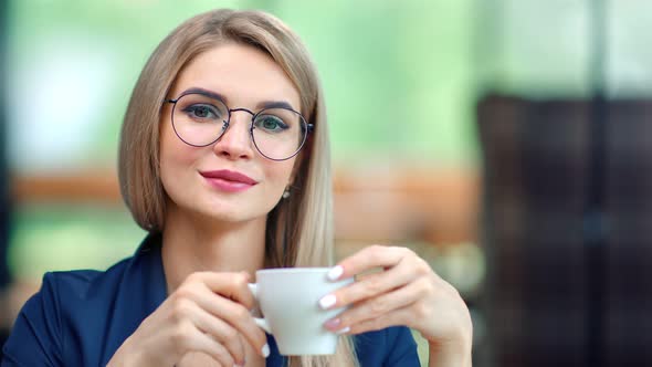 Portrait of Beautiful Informal Business Woman in Stylish Glasses Smiling Drinking Coffee From Cup