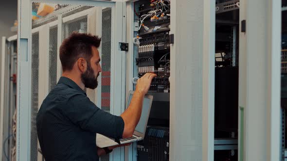 It Administrator In Mining Server Room And Connecting Ethernet Wire. Internet Network Switch.