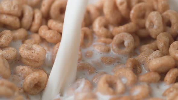 Pouring milk into cereal. Slow Motion.