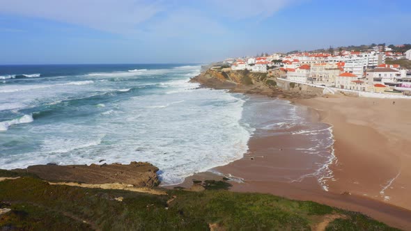 Aerial Drone View of Sandy Beach at Lisbon, Portugal at Praia das Macas, a Beautiful Coastal Town on