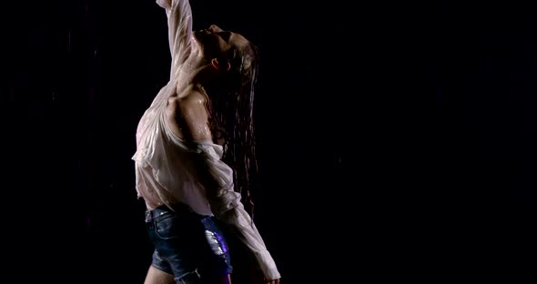 Beautiful Woman Is Dancing Under Rain in Darkness, Moving Hands