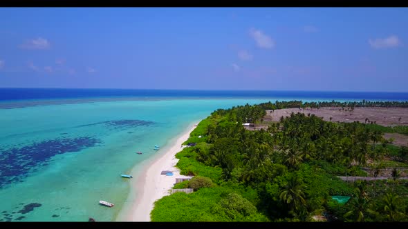 Aerial top down nature of tranquil seashore beach vacation by blue lagoon with white sand background