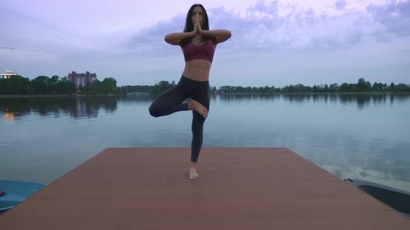 Woman Doing Yoga on Pier.