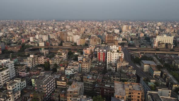 Smoggy skyline of Dhaka with traffic on highway, aerial view of densely built city