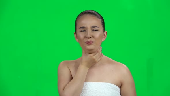 Young Woman in the Towel Gets Sick, She Has a Sore Throat, Cough, Fever. Green Screen. Slow Motion