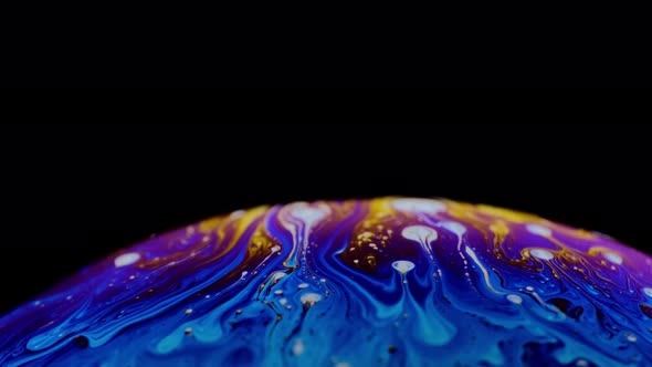 Multi-colored Iris of a Soap Bubble in Motion